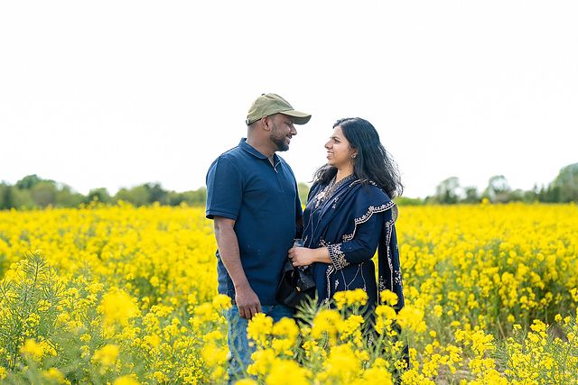 Couple in a field of rapeseed flowers